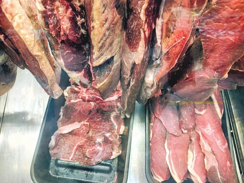 Pieces of meat displayed on a butcher's display stand