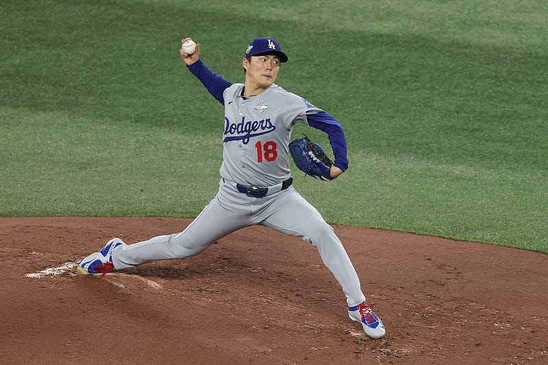 Yoshinobu Yamamoto #18 of the Los Angeles Dodgers pitches against the Toronto Blue Jays during the first inning in game six of the 2025 World Series at Rogers Center on October 31, 2025 in Toronto, Ontario.