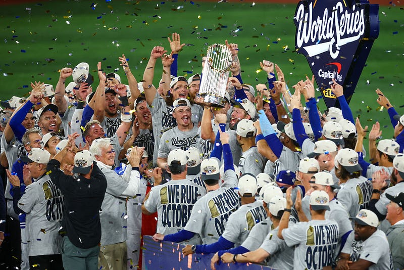 Clayton Kershaw #22 of the Los Angeles Dodgers raises the Commisioner's Trophy after defeating the Toronto Blue Jays 5-4 in game seven of the 2025 World Series at Rogers Center on November 02, 2025 in Toronto, Ontario.