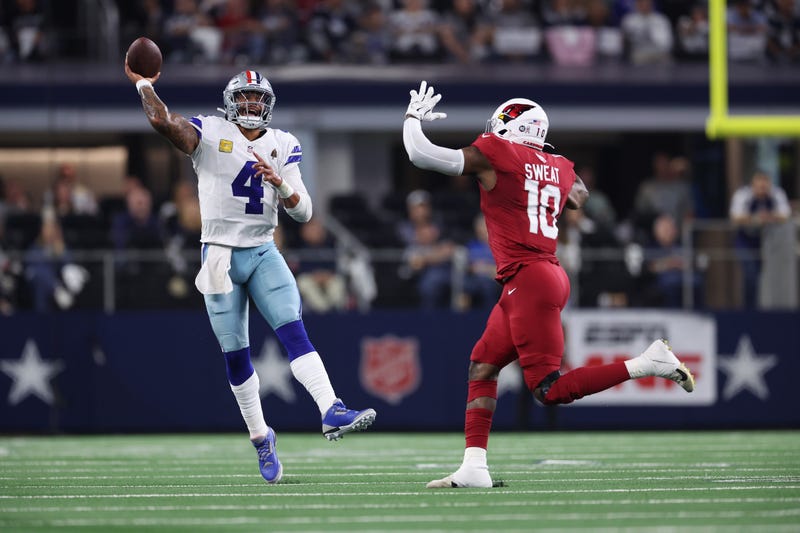 ARLINGTON, TEXAS - NOVEMBER 03: Dak Prescott #4 of the Dallas Cowboys throws ahead of Josh Sweat #10 of the Arizona Cardinals during the second quarter in the game at AT&T Stadium on November 03, 2025 in Arlington, Texas. (Photo by Sam Hodde/Getty Images)