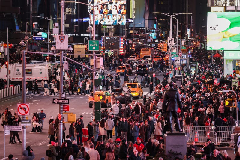Pedestrians and vehicles move through Times Square on Nov. 12, 2025