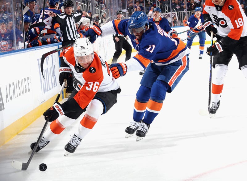 Anthony Duclair #11 of the New York Islanders checks Emil Andrae #36 of the Philadelphia Flyers during the second period at UBS Arena on November 28, 2025 in Elmont, New York. 