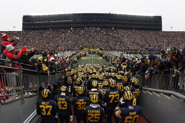 The Michigan Wolverines walk out of the tunnel before the game against the Ohio State Buckeyes at Michigan Stadium on November 29, 2025 in Ann Arbor, Michigan. 