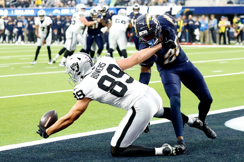 Brock Bowers #89 of the Las Vegas Raiders catches a touchdown against Cam Hart #20 of the Los Angeles Chargers in the fourth quarter of a game at SoFi Stadium on November 30, 2025 in Inglewood, California. 