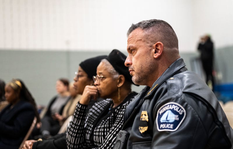 Minneapolis Police Chief Brian O'Hara (R) looks on during an interfaith prayer for the Somali community of Minnesota at Brian Coyle Community Center on December 4, 2025 in Minneapolis, Minnesota. The Trump administration has targeted the Somali immigrant community as ICE increased operations in Minnesota this week. 