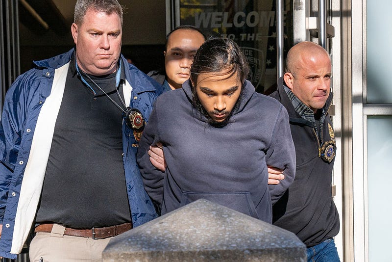 Hiram Carrero, 18, accused of lighting a homeless man on fire aboard a northbound number 3 train, is taken from the New York Police Department 9th Precinct in Manhattan on Thursday Dec. 4, 2025. 