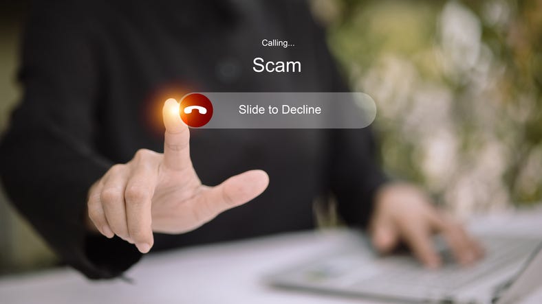 Finger rejecting scam call on smartphone with slide to decline interface, concept of phone fraud prevention and scam awareness.