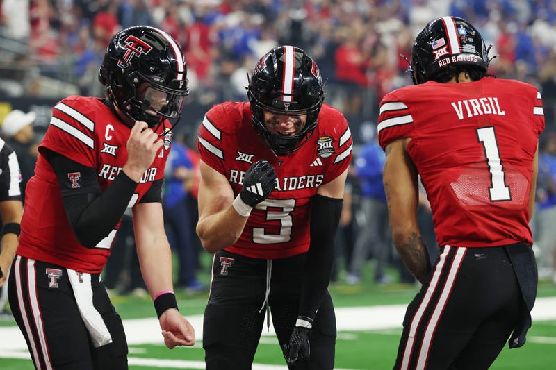 Coy Eakin #3 of the Texas Tech Red Raiders celebrates with Behren Morton #2 and Reggie Virgil #1 after scoring a receiving touchdown against the BYU Cougars during the fourth quarter in the 2025 Edward Jones Big 12 Championship at AT&T Stadium on Dec. 6, 2025 in Arlington, Texas.