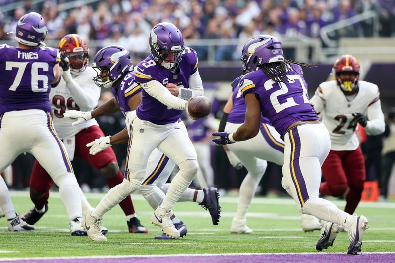 J.J. McCarthy #9 of the Minnesota Vikings hands off to Jordan Mason #27 of the Minnesota Vikings during the first quarter against the Washington Commanders at U.S. Bank Stadium on December 07, 2025 in Minneapolis, Minnesota. 