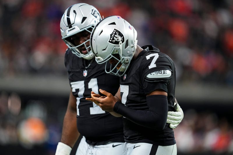 Geno Smith #7 of the Las Vegas Raiders looks at his hand after a play during the third quarter against the Denver Broncos at Allegiant Stadium on December 07, 2025 in Las Vegas, Nevada.