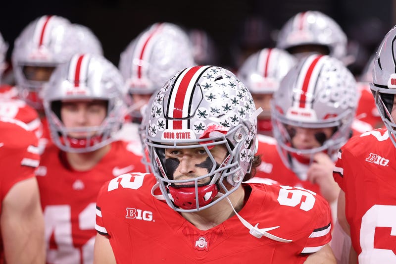 INDIANAPOLIS, INDIANA - DECEMBER 06: Caden Curry #92 of the Ohio State Buckeyes leads his team on to the field prior to the game against the Indiana Hoosiers in the 2025 Big Ten Football Championship at Lucas Oil Stadium on December 06, 2025 in Indianapolis, Indiana. (Photo by Michael Reaves/Getty Images)