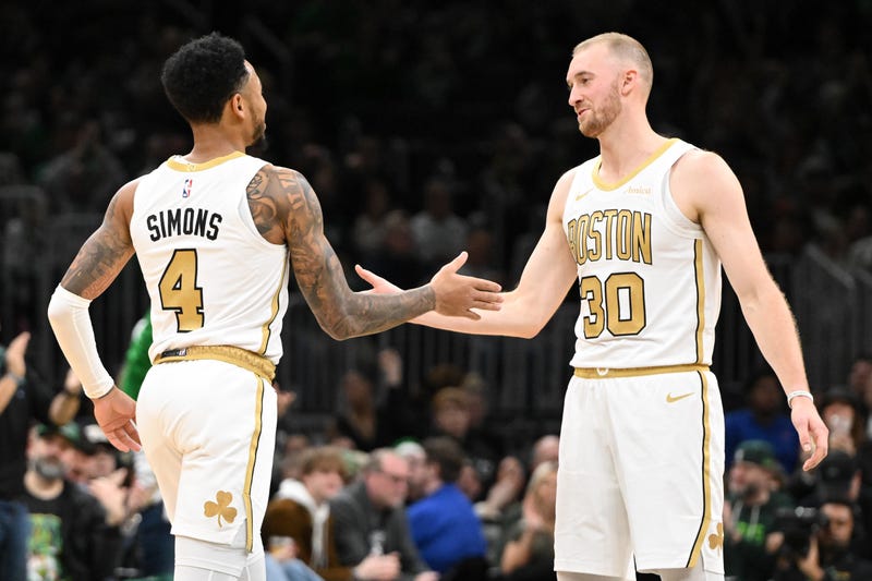 Sam Hauser #30 of the Boston Celtics reacts with Anfernee Simons #4 after scoring a basket against the Miami Heat during the second half at the TD Garden on December 19, 2025 in Boston, Massachusetts.