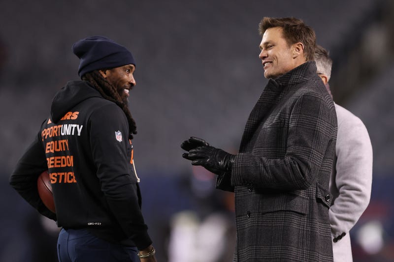 Fox Sports commentator Tom Brady talks with defensive backs coach Al Harris of the Chicago Bears prior to the game between the Chicago Bears and the Green Bay Packers at Soldier Field on December 20, 2025 in Chicago, Illinois
