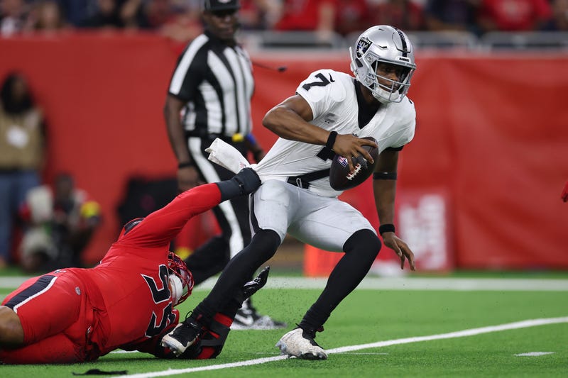 Geno Smith #7 of the Las Vegas Raiders is sacked by Derek Barnett #95 of the Houston Texans during the third quarter at NRG Stadium on December 21, 2025 in Houston, Texas. 