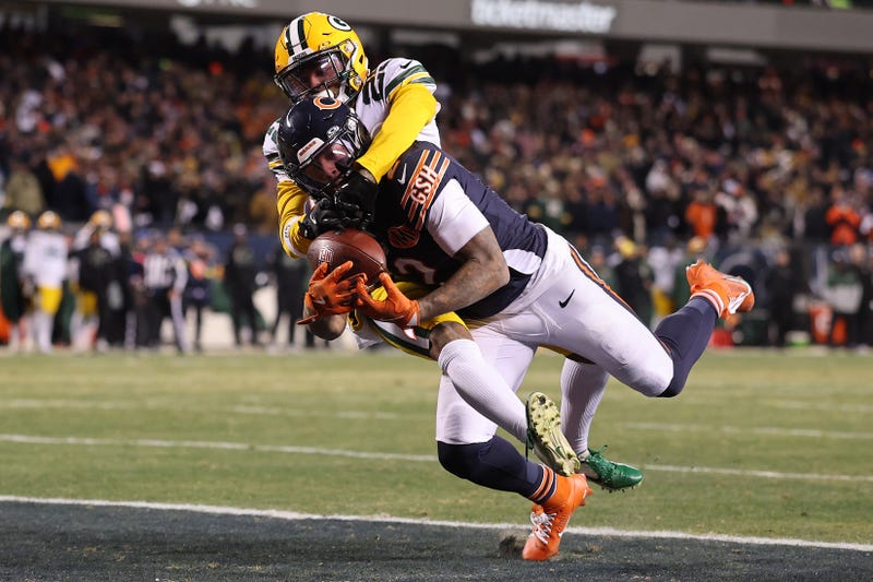 DJ Moore #2 of the Chicago Bears catches a game-winning touchdown pass against Keisean Nixon #25 of the Green Bay Packers in overtime at Soldier Field on December 20, 2025 in Chicago, Illinois. 