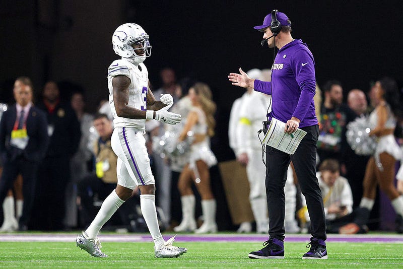 Jordan Addison #3 of the Minnesota Vikings is congratulated by head coach Kevin O'Connell after scoring a rushing touchdown against the Detroit Lions during the fourth quarter at U.S. Bank Stadium on December 25, 2025 in Minneapolis, Minnesota. 