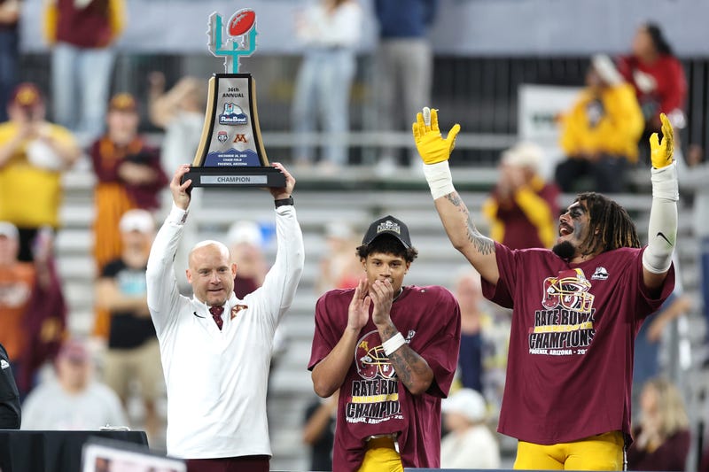 Head coach P.J. Fleck of the Minnesota Golden Gophers holds the championship trophy after beating the New Mexico Lobos 20-17 in overtime of the 2025 Rate Bowl at Chase Field on December 26, 2025 in Phoenix, Arizona.