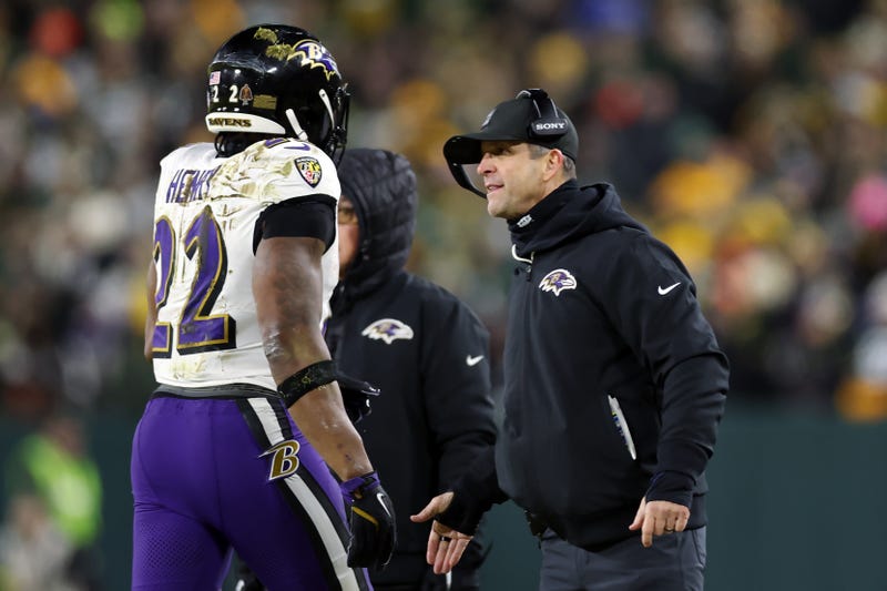 Derrick Henry #22 and head coach John Harbaugh of the Baltimore Ravens celebrate after scoring a touchdown in the first quarter against the Green Bay Packers at Lambeau Field on December 27, 2025 in Green Bay, Wisconsin.