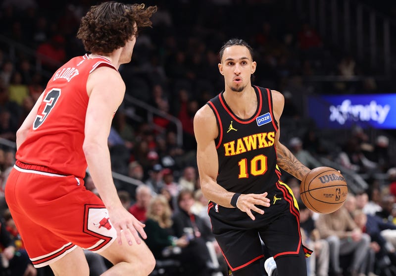 ATLANTA, GEORGIA - DECEMBER 21: Zaccharie Risacher #10 of the Atlanta Hawks drives against Josh Giddey #3 of the Chicago Bulls during the first quarter at State Farm Arena on December 21, 2025 in Atlanta, Georgia