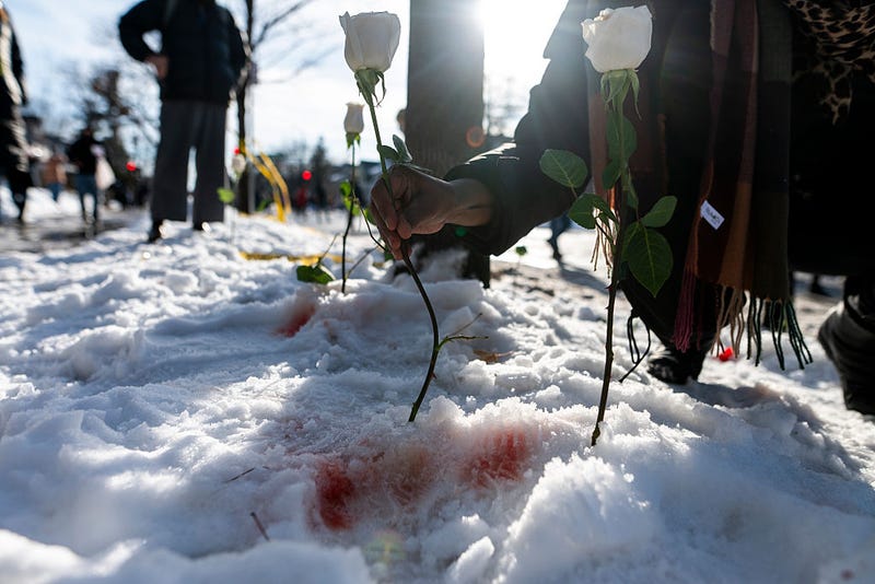 A person places a flower at the site where a woman was reportedly shot and killed by an ICE agent during federal law enforcement operations on January 07, 2026 in Minneapolis, Minnesota. According to federal officials, the agent, "fearing for his life" killed a woman during a confrontation in south Minneapolis. 