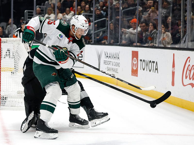 Jonas Brodin #25 of the Minnesota Wild clears the puck from Anze Kopitar #11 of the Los Angeles Kings in overtime during a 5-4 Kings overtime shootout win at Crypto.com Arena on January 03, 2026 in Los Angeles, California. 
