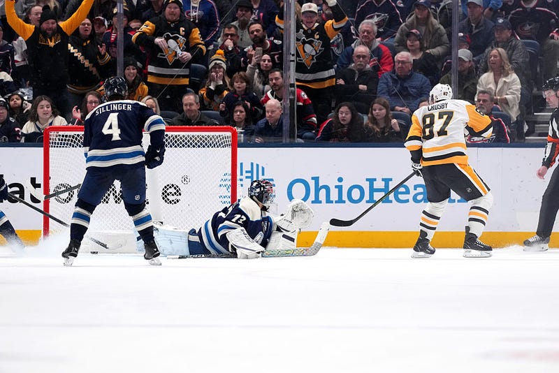 Sidney Crosby #87 of the Pittsburgh Penguins scores the game winning goal on Jet Greaves #73 of the Columbus Blue Jackets in overtime at Nationwide Arena on January 04, 2026 in Columbus, Ohio. 