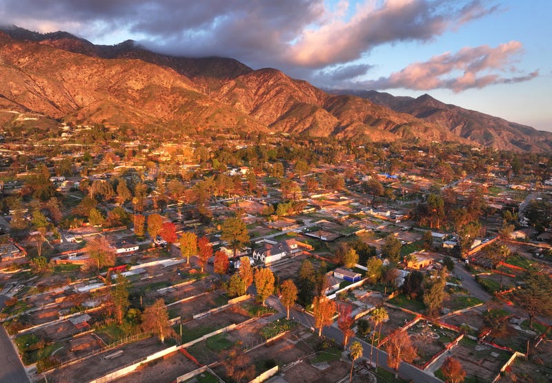An aerial view of surviving trees amid cleared lots where homes were destroyed by the Eaton Fire nearly one year ago as rebuilding efforts continue on December 27, 2025 in Altadena, California.