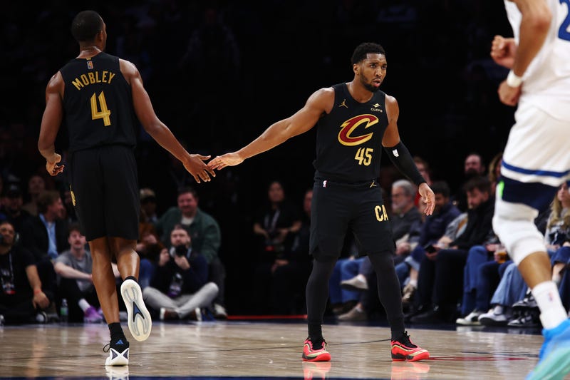 Donovan Mitchell #45 of the Cleveland Cavaliers high-fives Evan Mobley #4 during the second half at Target Center on January 08, 2026 in Minneapolis, Minnesota. The Timberwolves beat the Cavaliers 131-122.