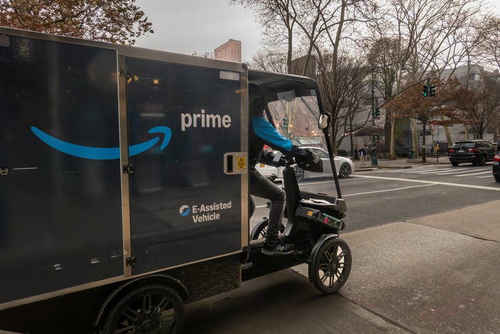 New York, NY USA Dec 6, 2025 A man drives an E-Assisted Vehicle for Amazon Prime delivery on Columbus Avenue.