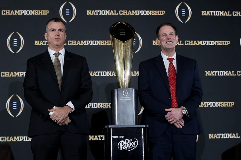 Head Coaches Mario Cristobal of the Miami Hurricanes and Curt Cignetti of the Indiana Hoosiers pose for a photo with the CFP National Championship trophy during the CFP National Championship Head Coaches News Conference at JW Marriott Marquis Miami on January 18, 2026 in Miami, Florida.