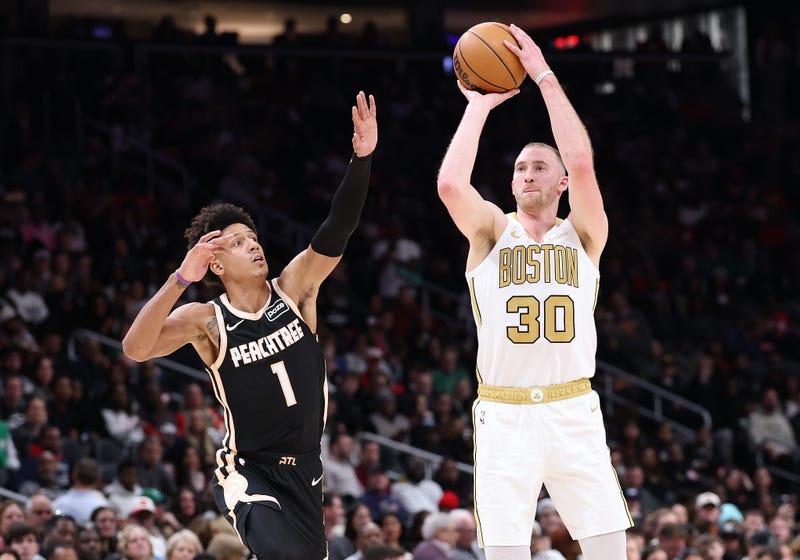 Sam Hauser #30 of the Boston Celtics shoots a three-point basket against Jalen Johnson #1 of the Atlanta Hawks during the second quarter at State Farm Arena on January 17, 2026 in Atlanta, Georgia.