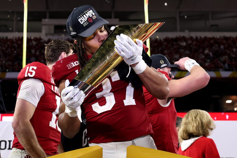 Riley Nowakowski #37 of the Indiana Hoosiers kisses the College Football Playoff National Championship Trophy after defeating Miami Hurricanes 27-21 in the 2026 College Football Playoff National Championship at Hard Rock Stadium on January 19, 2026 in Miami Gardens, Florida.