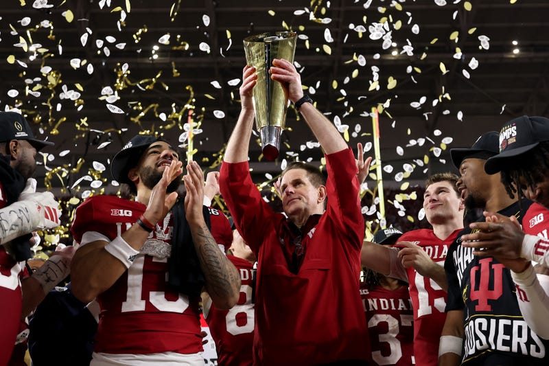 MIAMI GARDENS, FLORIDA - JANUARY 19: Head coach Curt Cignetti of the Indiana Hoosiers hoists the College Football Playoff National Championship Trophy after defeating the Miami Hurricanes 27-21 in the 2026 College Football Playoff National Championship at Hard Rock Stadium on January 19, 2026 in Miami Gardens, Florida.