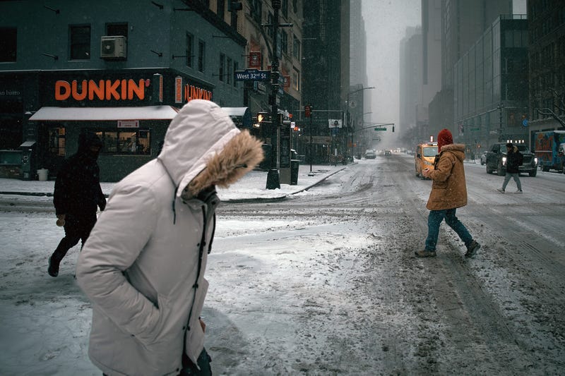 A person crosses the street in Midtown during the snowstorm on Jan. 25, 2026