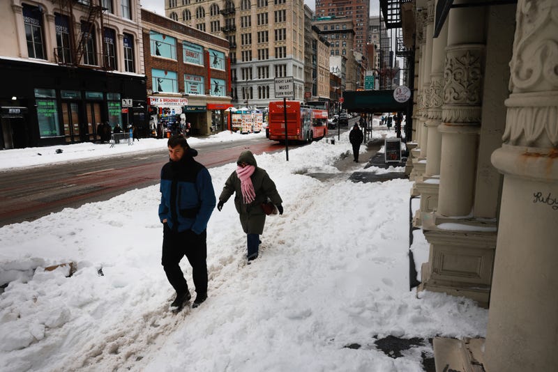 People walk through the snow in Manhattan on Monday amid brutally cold temperatures