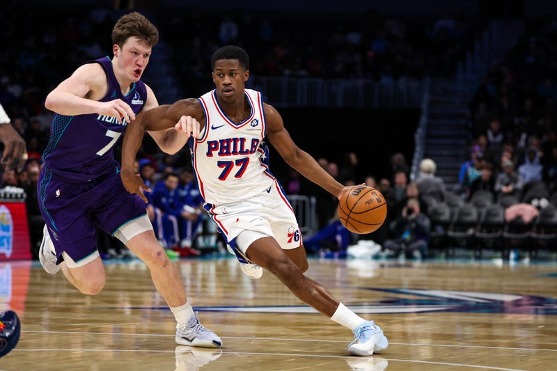  V.J. Edgecombe #77 of the Philadelphia 76ers drives by Kon Knueppel #7 of the Charlotte Hornets during the second half at Spectrum Center on January 26, 2026 in Charlotte, North Carolina.