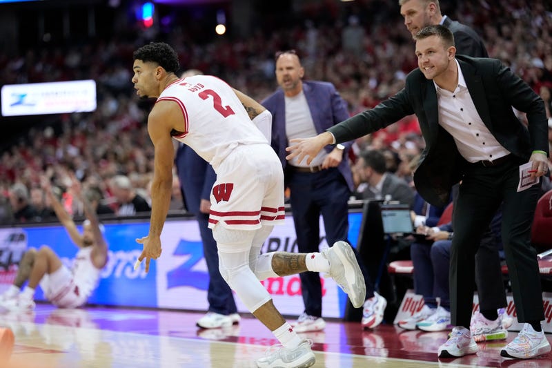 Nick Boyd #2 of the Wisconsin Badgers reacts after a made three point shot as assistant coach Brad Davison looks on during the second half of the game against the Ohio State Buckeyes at Kohl Center on January 31, 2026 in Madison, Wisconsin
