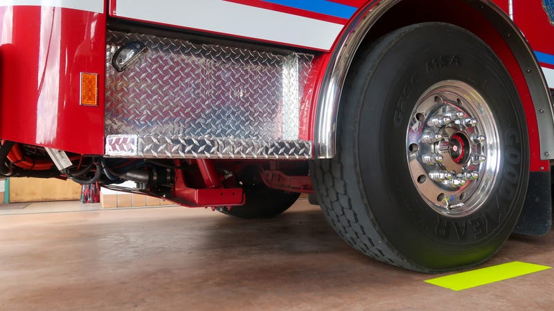 Detail of fire engine wheel and chrome diamond plate - stock photo