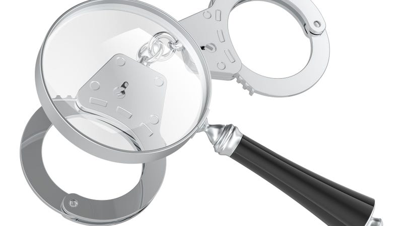 Magnifying glass with handcuffs, 3D rendering - stock photo