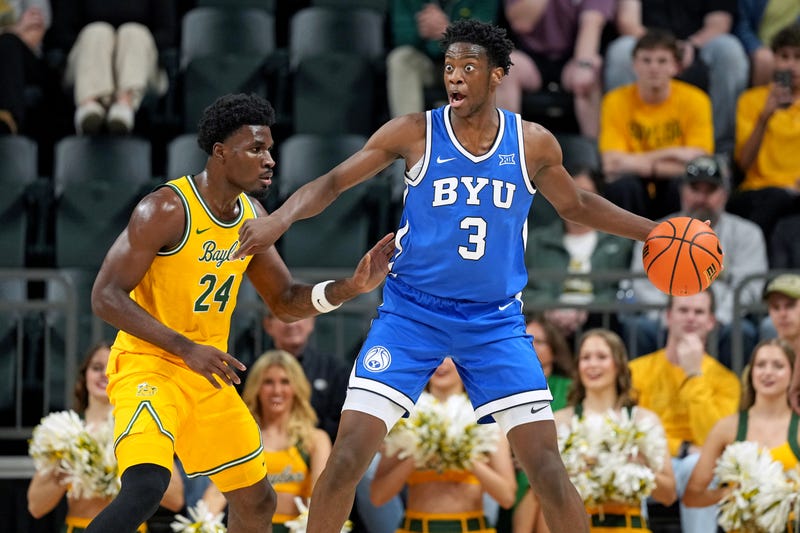AJ Dybantsa #3 the BYU Cougars signals to teammates as he is defended by Tounde Yessoufou #24 of the Baylor Bears during the first half at Foster Pavilion on February 10, 2026 in Waco, Texas.