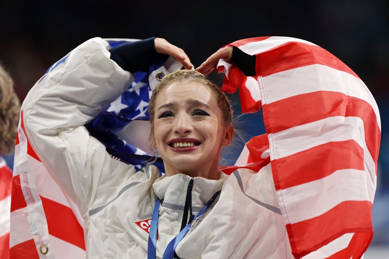 MILAN, ITALY - FEBRUARY 08: Gold medalist Amber Glenn of Team United States acknowledges the crowd following the Medal Ceremony for the Team Event after the Men's Single Skating - Free Skating Team Event on day two of the Milano Cortina 2026 Winter Olympic games at Milano Ice Skating Arena on February 08, 2026 in Milan, Italy. (Photo by Jamie Squire/Getty Images)