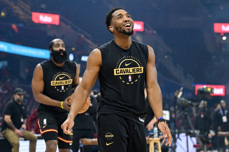 Donovan Mitchell #45 and James Harden #1 of the Cleveland Cavaliers warm up prior to a game against the Washington Wizards at Rocket Arena on February 11, 2026 in Cleveland, Ohio