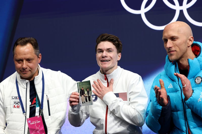 Maxim Naumov of USA, who grew up in Simsbury, reacts while holding a picture of his family after competing in Men's Single Skating - Short Program on day four of the Winter Olympics in Milan, Italy. 