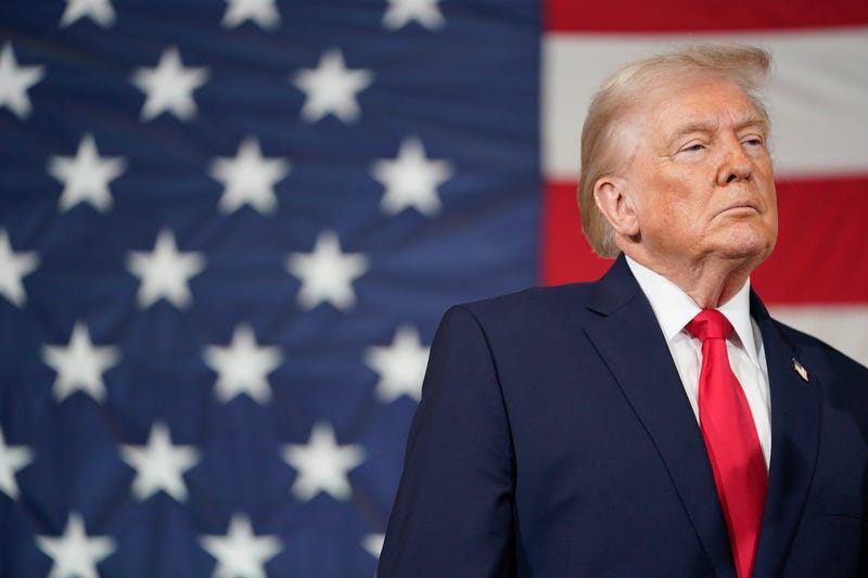 President Donald Trump standing in front of an American flag