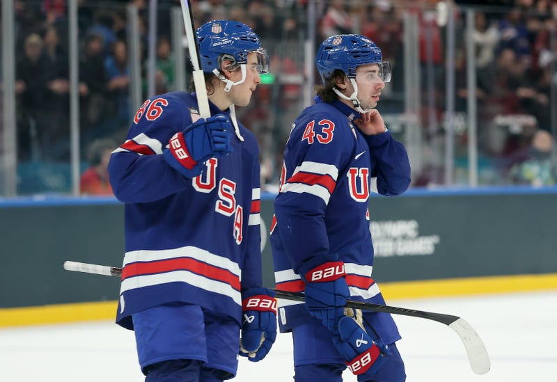 MILAN, ITALY - FEBRUARY 14: Jack Hughes #86 and Quinn Hughes #43 of Team United States celebrate after the victory in the Men's Preliminary Group C match between the United States and Denmark on day eight of the Milano Cortina 2026 Winter Olympic games at Milano Santagiulia Ice Hockey Arena on February 14, 2026 in Milan, Italy. 
