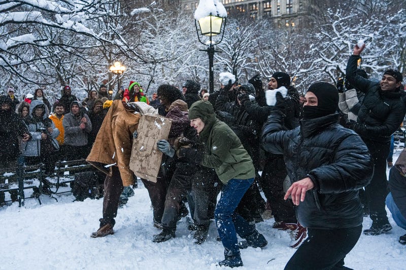 People throw snowballs at each other during the planned snowball fight in Washington Square Park on Monday