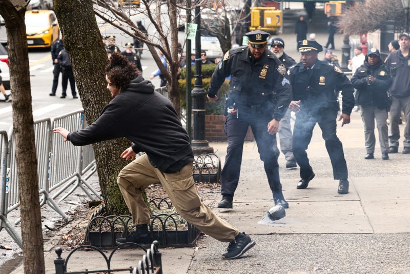 Photos show NYPD Chief Aaron Edwards and NYPD Sgt. Luis Navarro chasing the suspects near Gracie Mansion on March 7, 2026