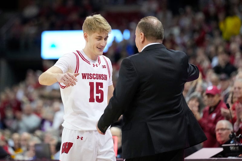 Isaac Gard #15 of the Wisconsin Badgers walks off the court and hugs his dad, head coach Greg Gard, in final seconds of a game against the Maryland Terrapins at Kohl Center on March 04, 2026 in Madison, Wisconsin