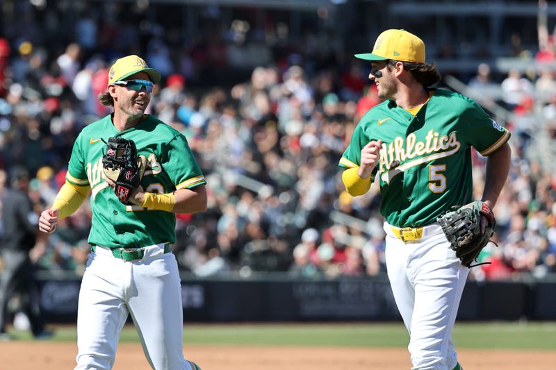 Jeff McNeil #22 and Jacob Wilson #5 of the Athletics run off the field after the Athletics turned a double play against the Los Angeles Angels in the second inning of a spring training game at Las Vegas Ballpark on March 07, 2026 in Las Vegas, Nevada. 