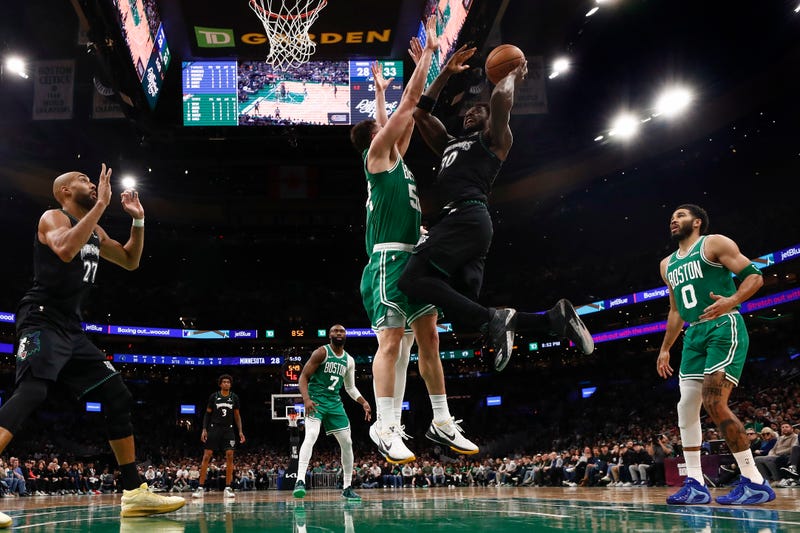 Minnesota Timberwolves getds off a shot against Luka Garza #52 of the Boston Celtics during the second half at TD Garden on March 22, 2026 in Boston, Massachusetts.